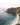 Rocky coastline with cliffs and turquoise waves under an overcast sky