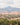 Desert landscape with sparse greenery and layered mountain backdrop