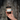 Hand holding a jar of 'Timberline Trail' bath salts against a tree bark background